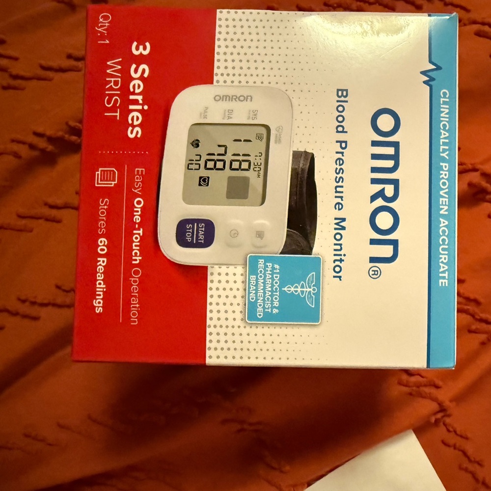 OMRON White and Black Wrist Blood Pressure Monitor with Blue Button Accent